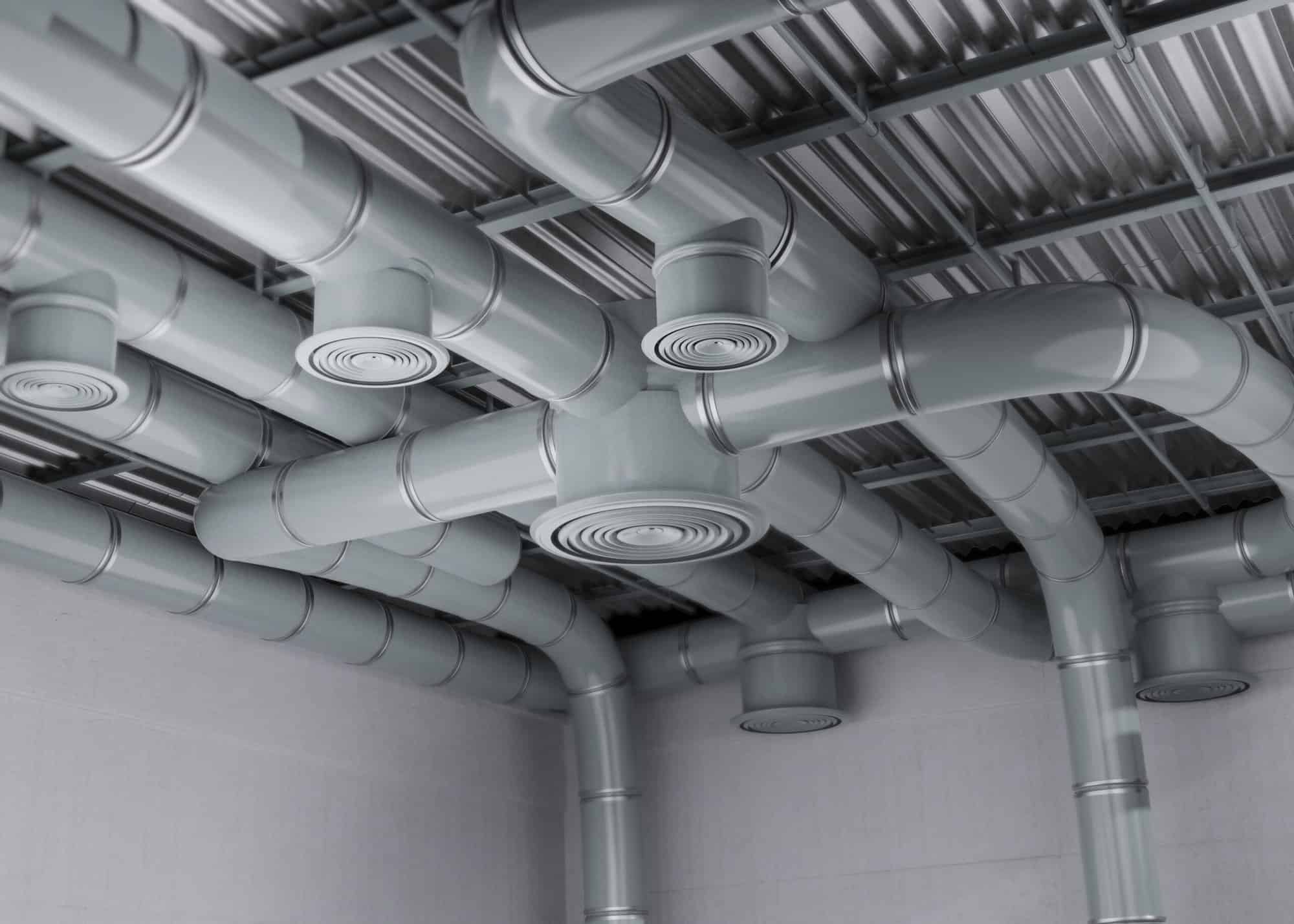HVAC pipe work running allong the ceiling of a commercial building.