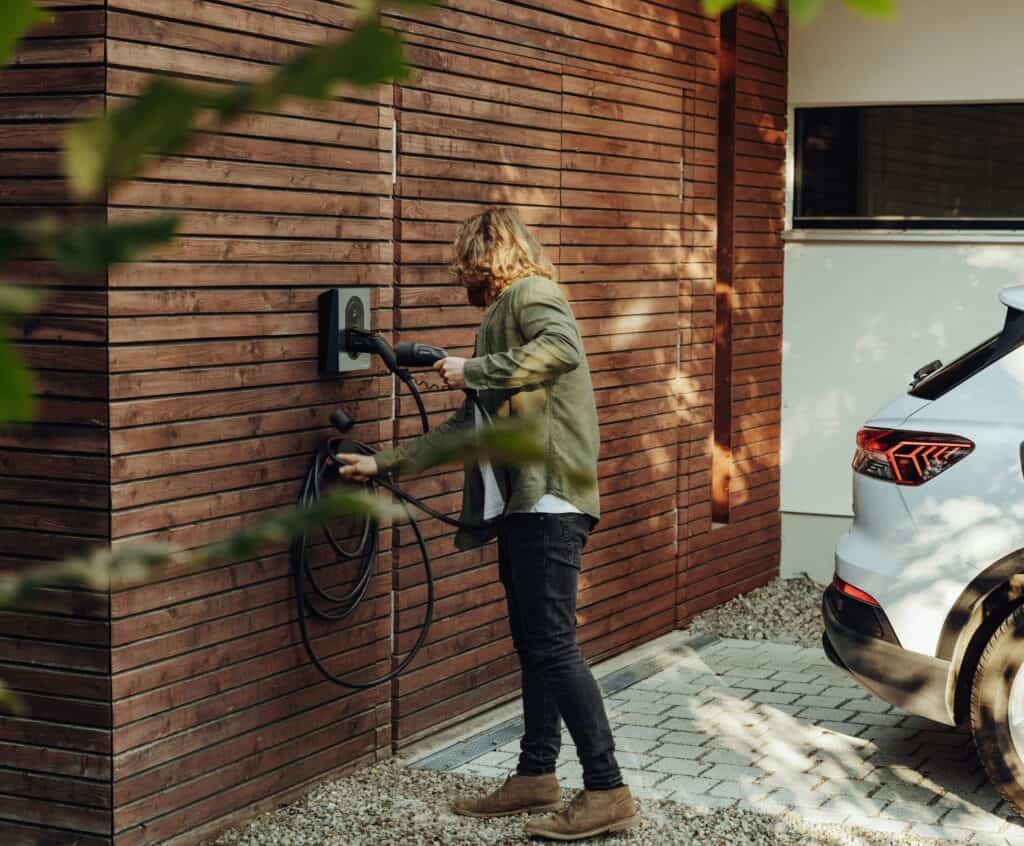 A person using a modern EV charger.